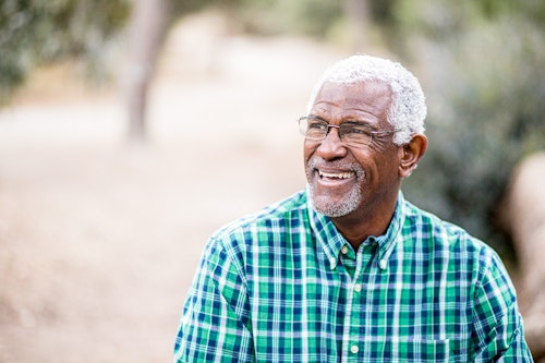 Older man outside in plaid shirt