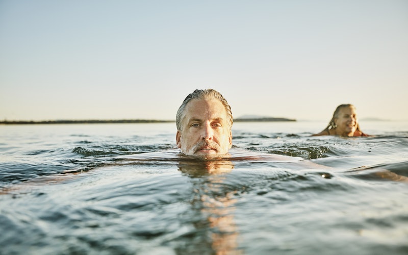older man swimming outside in the ocean