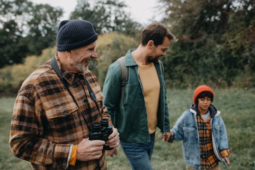 family walking outdoors with grandfather