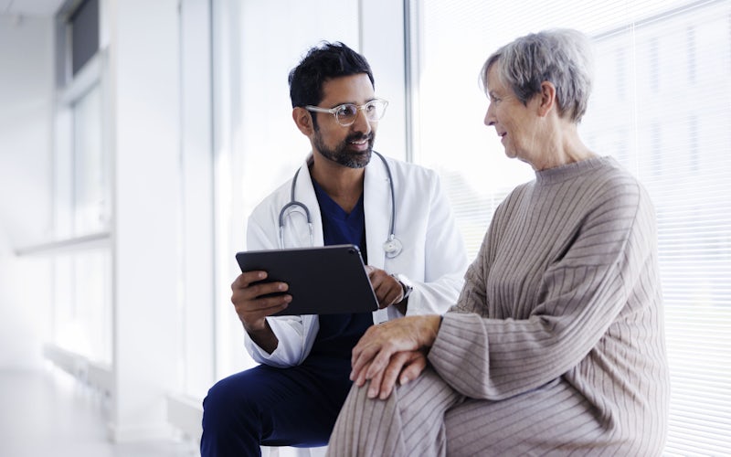 doctor and patient discussing over tablet