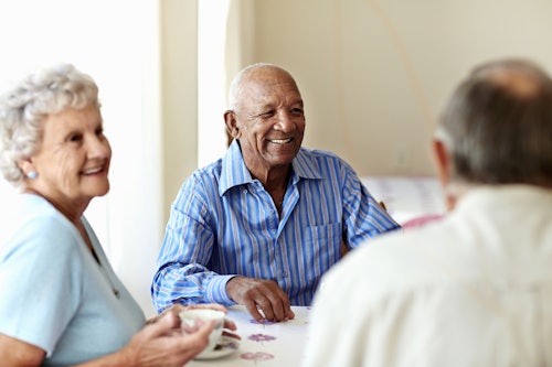 older patients laughing around a table