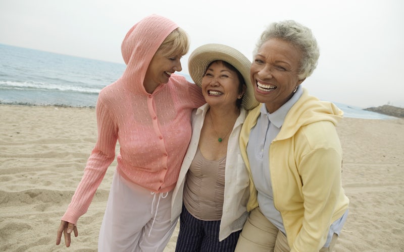 Group of women smiling on a beach together