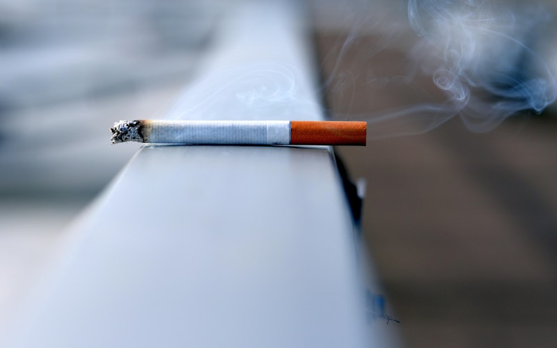 cigarette on a ledge smoking