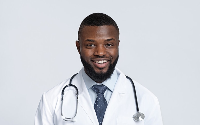 A headshot of a doctor smiling.