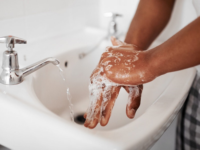 A closeup of a person washing their hands with soap.