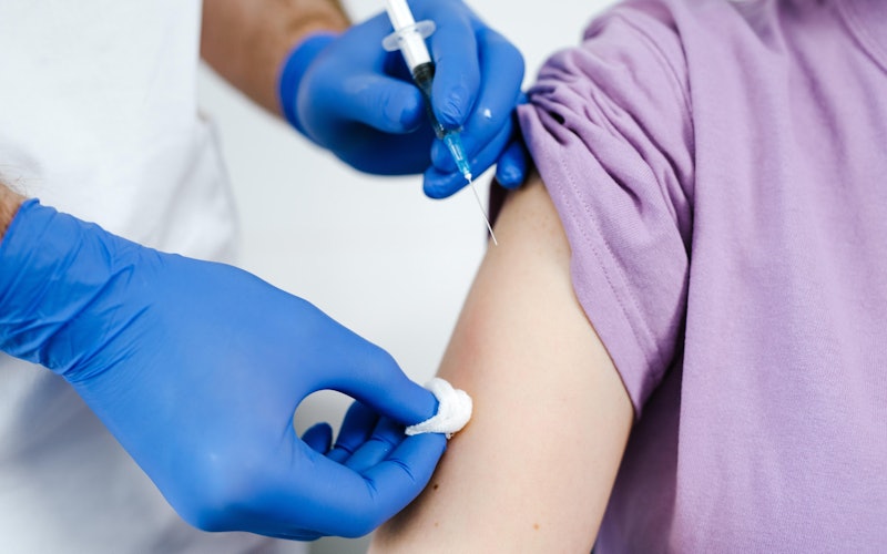 Close-Up Shot of a Health Worker Injecting a Vaccine on a Patient