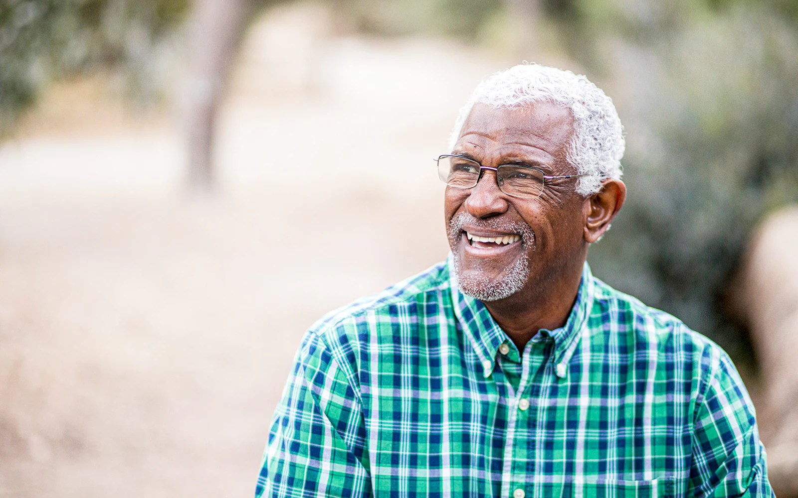 Older man outside in plaid shirt