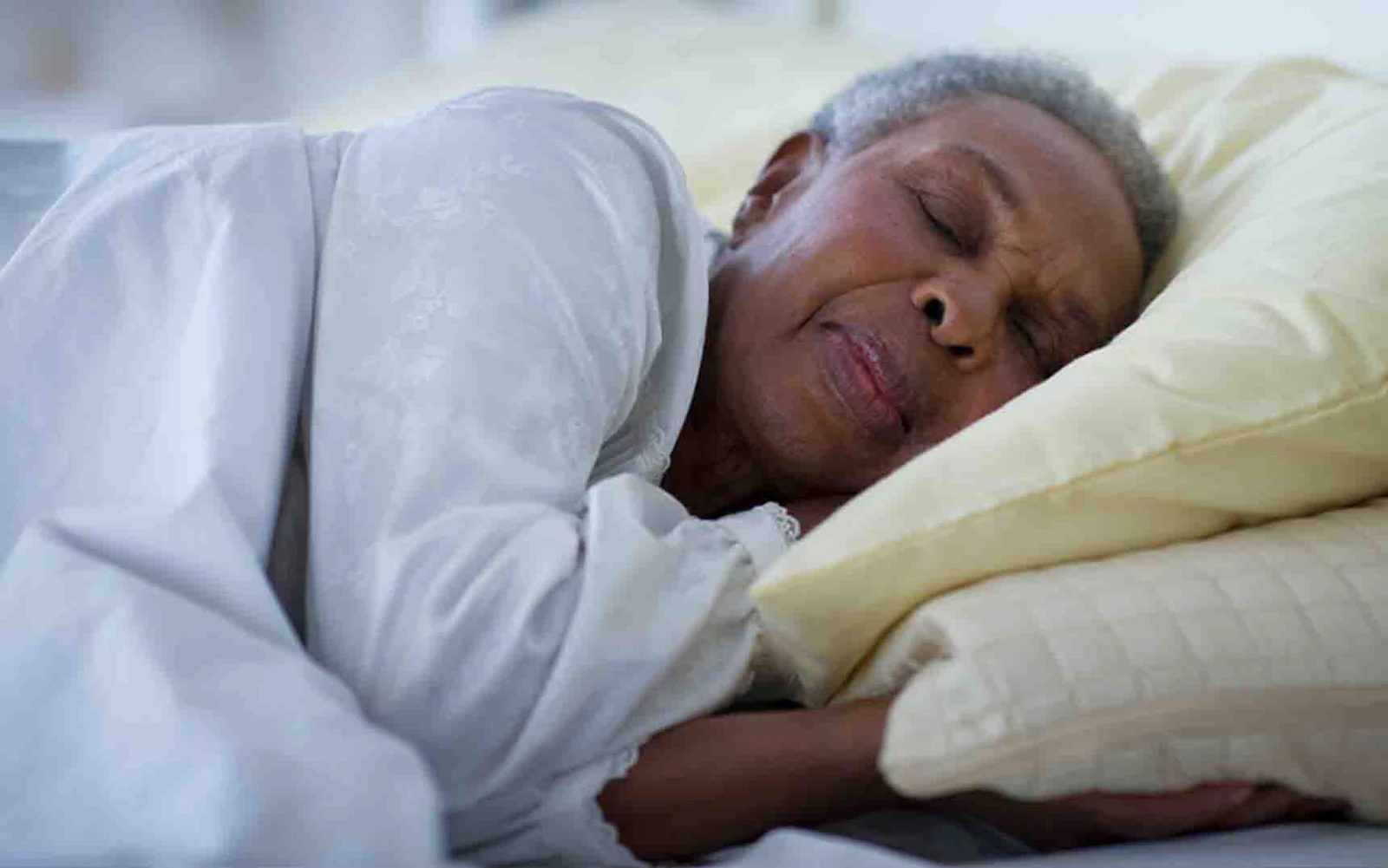 senior woman sleeping in a side position in bed