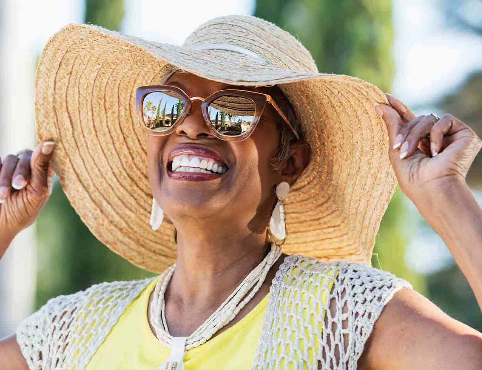woman wearing a hat and sunglass for sun safety