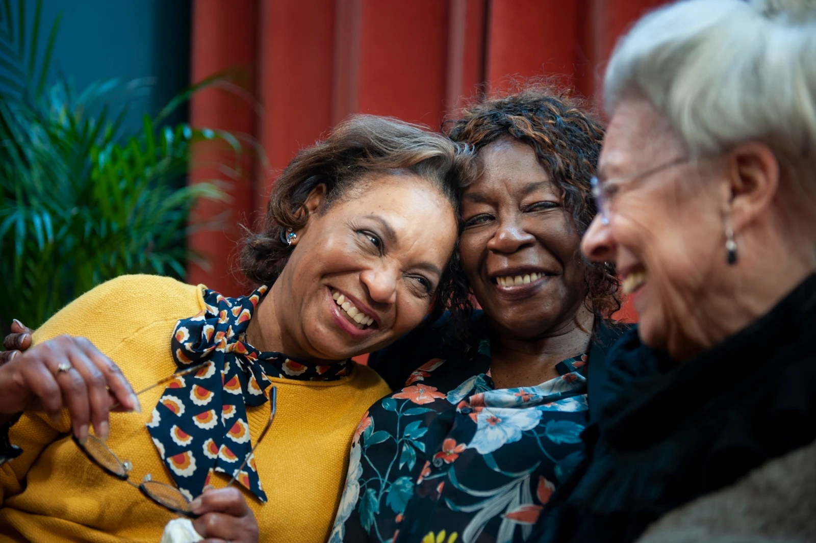 three ladies smiling together outside