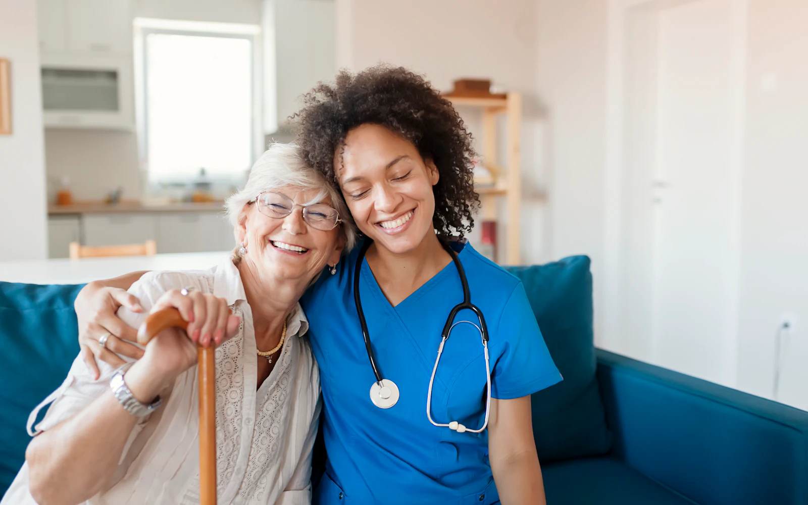 doctor leaning to hug patient that has cane