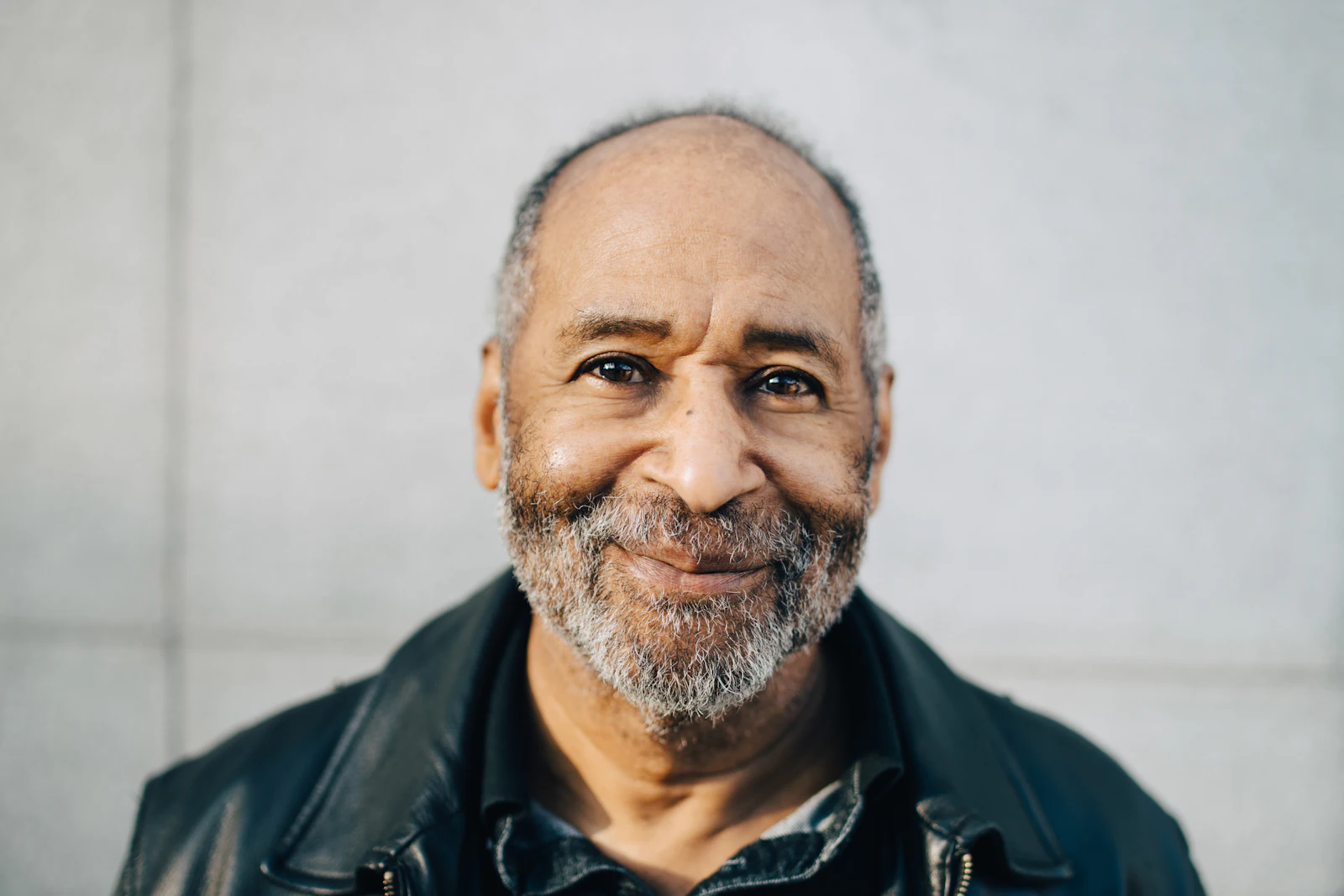 older man standing outside smiling