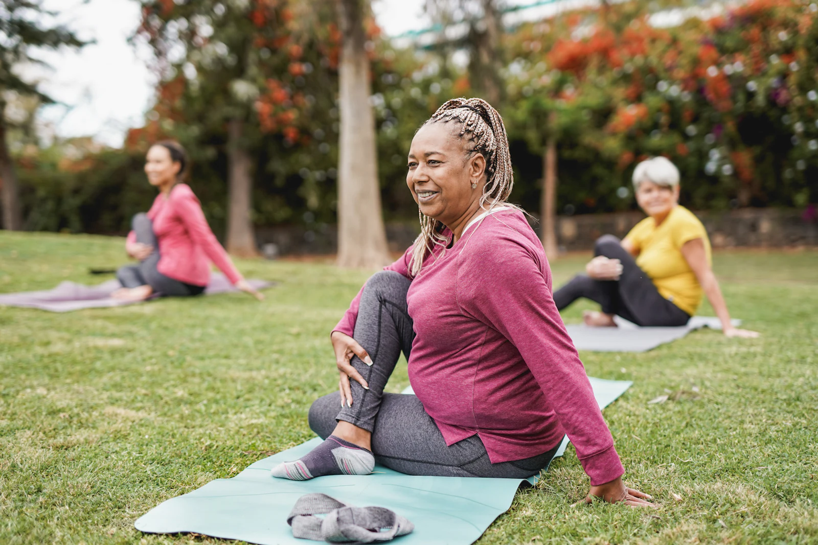 woman doing yoga outdoors on grass