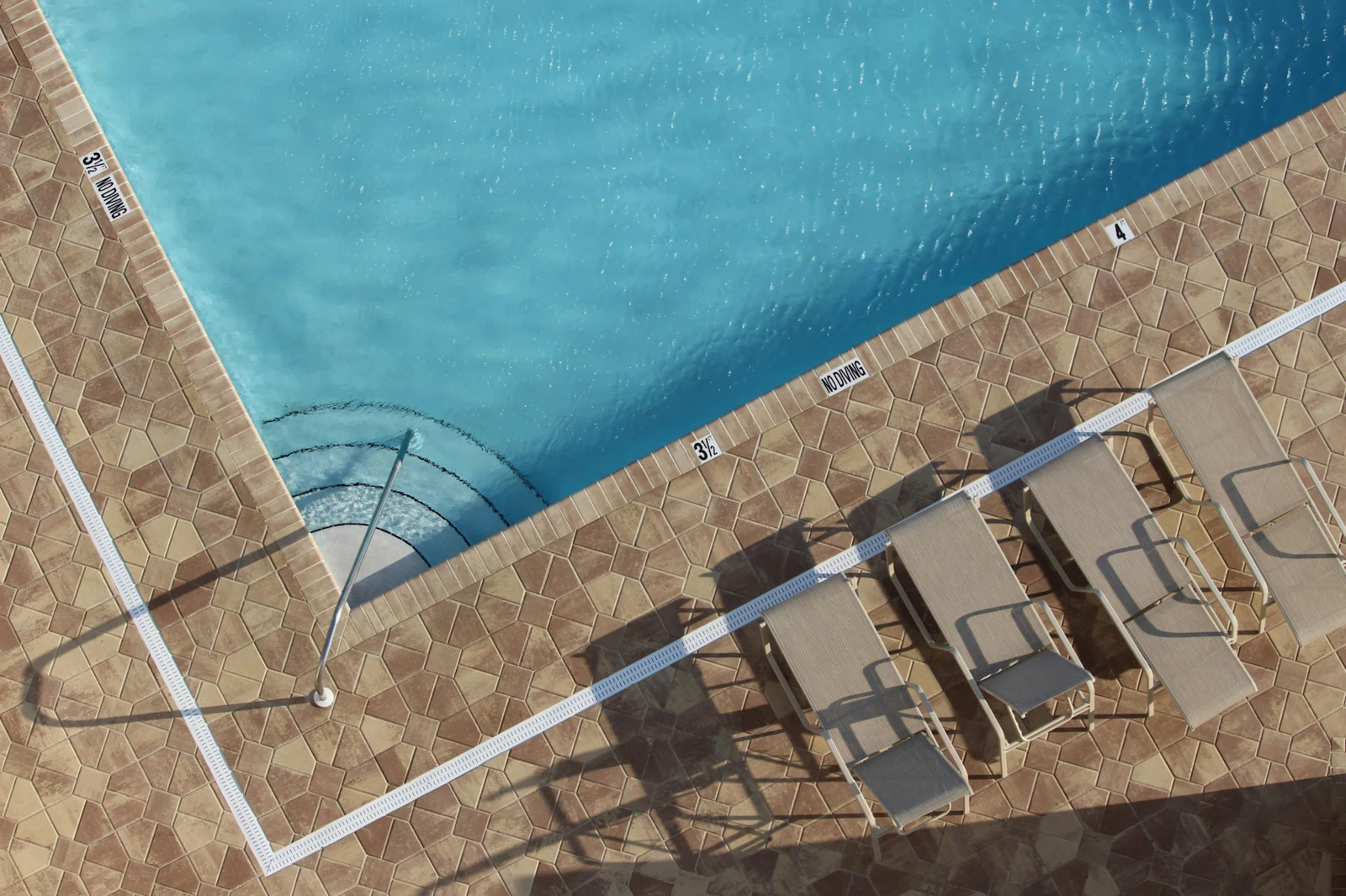 corner of outdoor swimming pool in sunshine