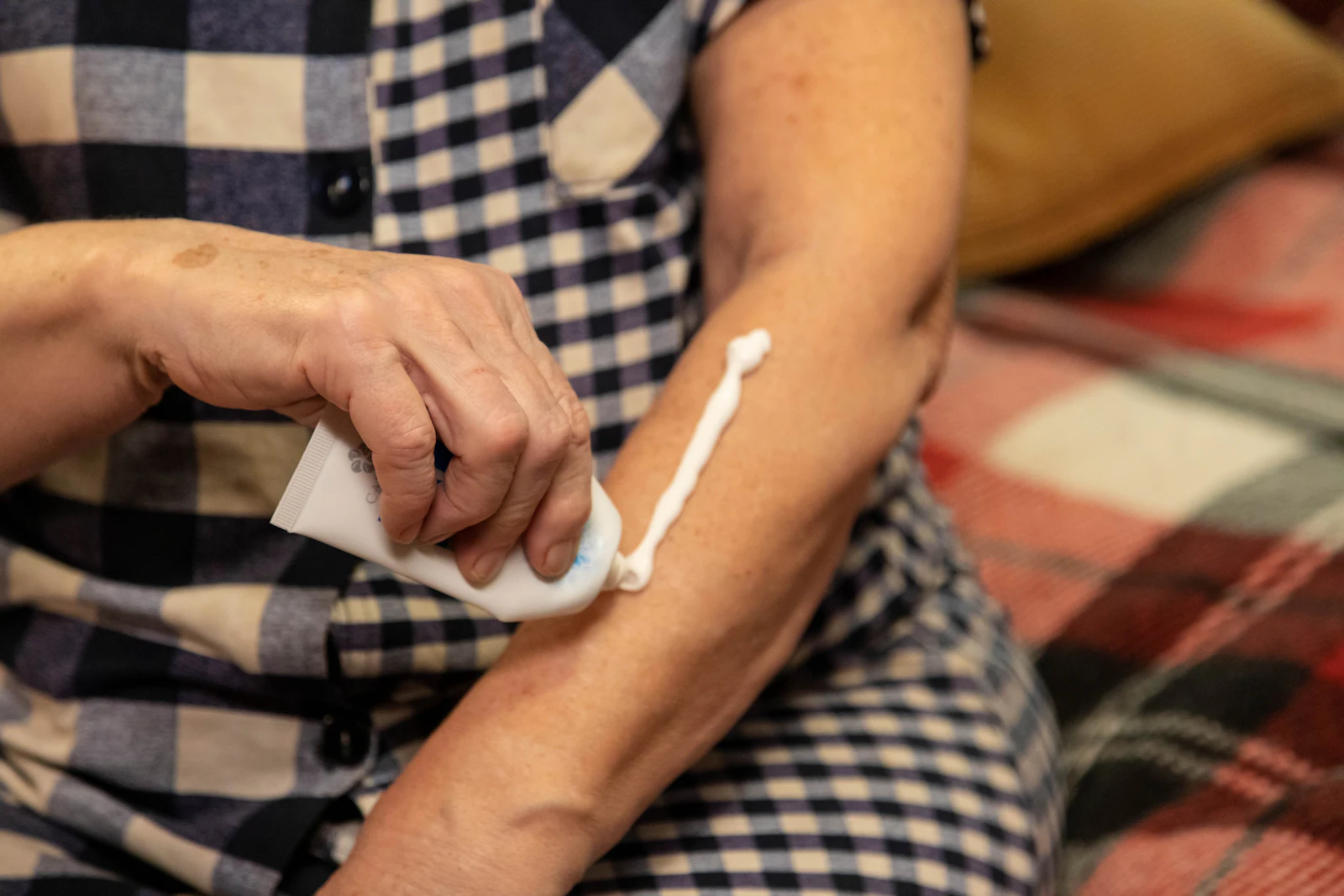 applying sunscreen on arm