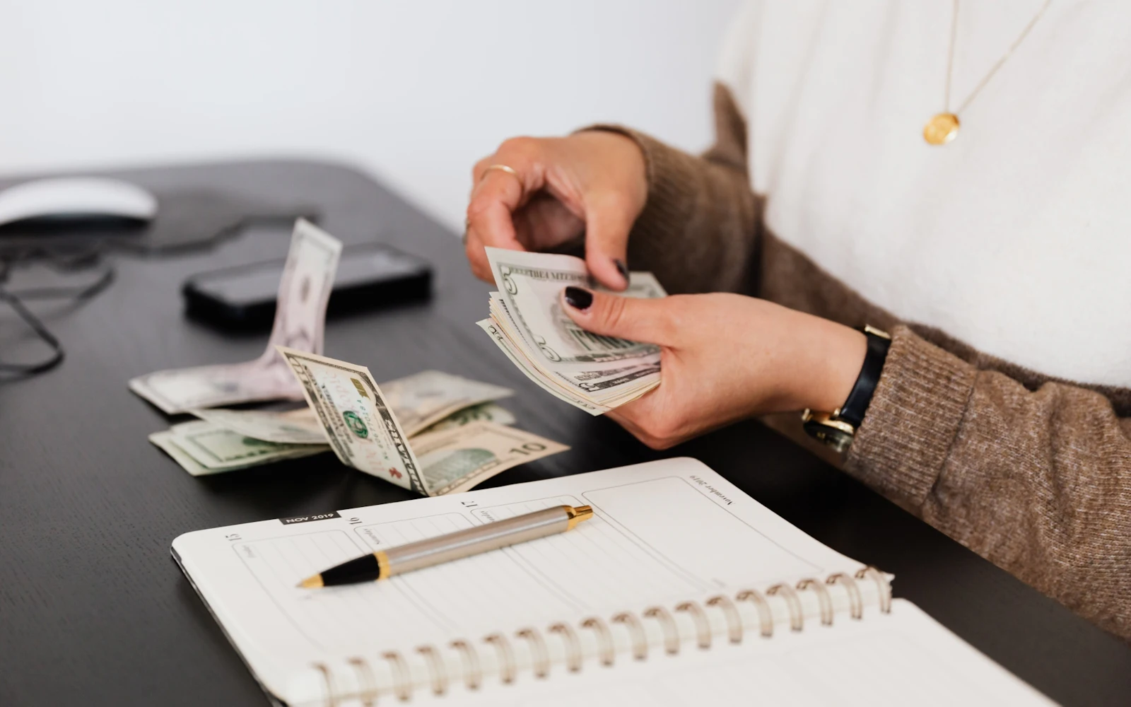 hand counting money over desk