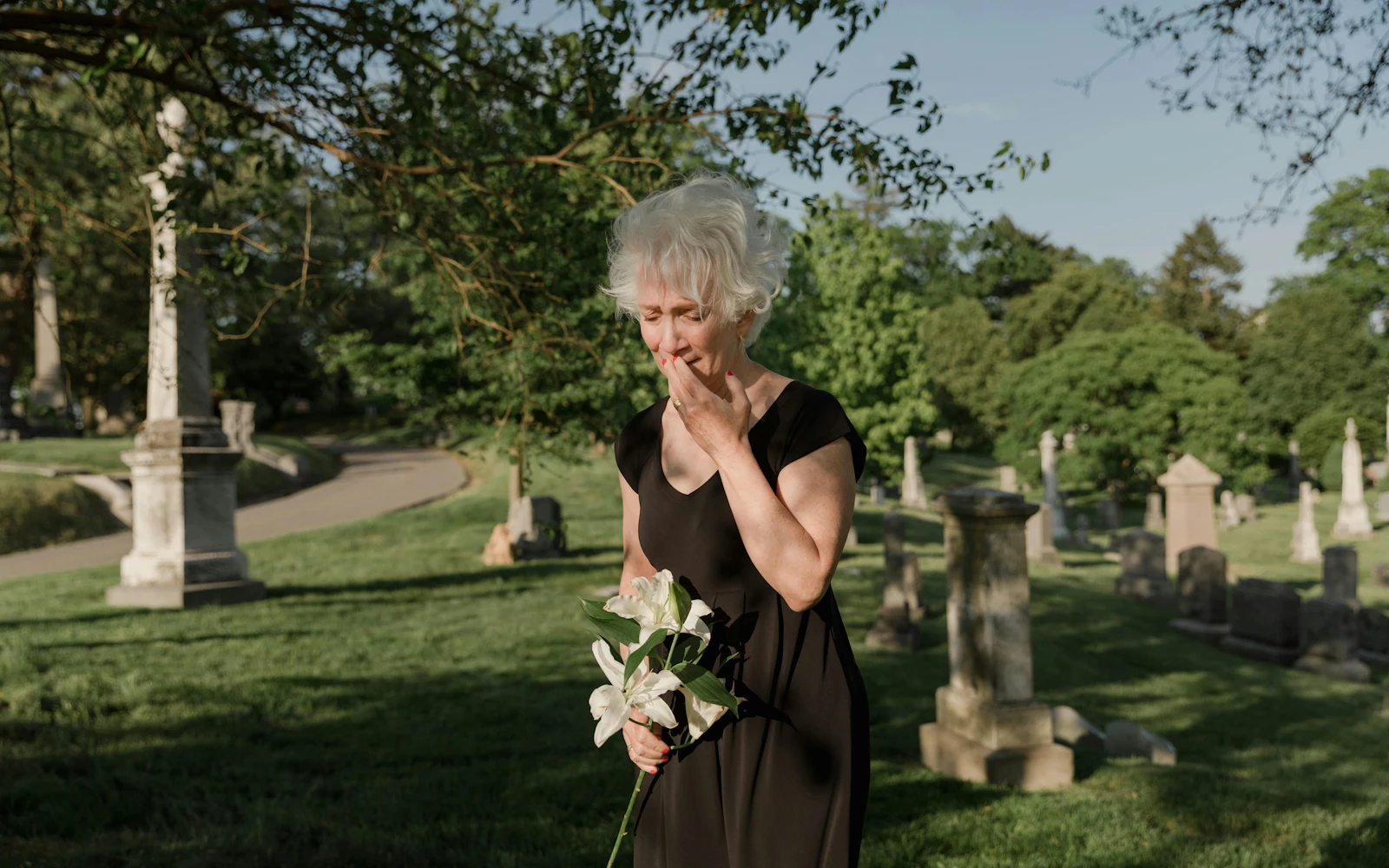 Woman wearing black at cemetary, grief, sadness