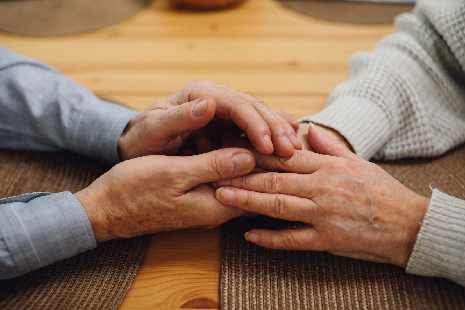 couple holding hands across the table