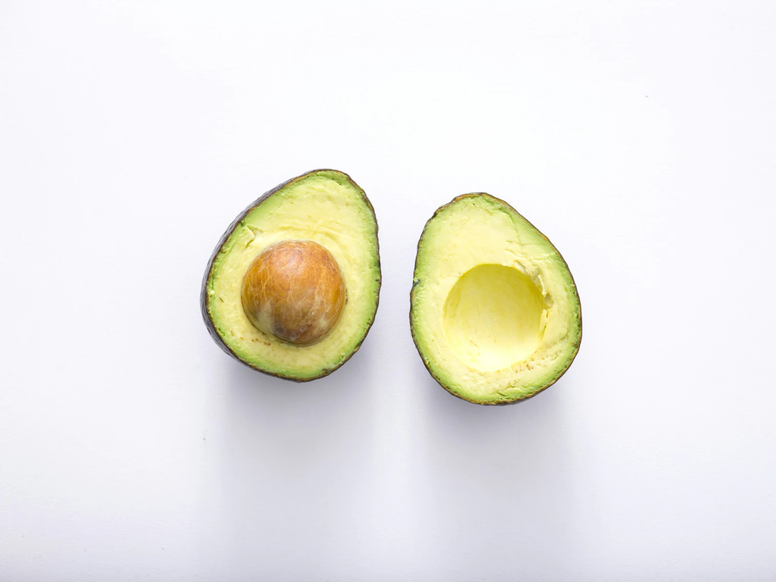 avocado cut open white background