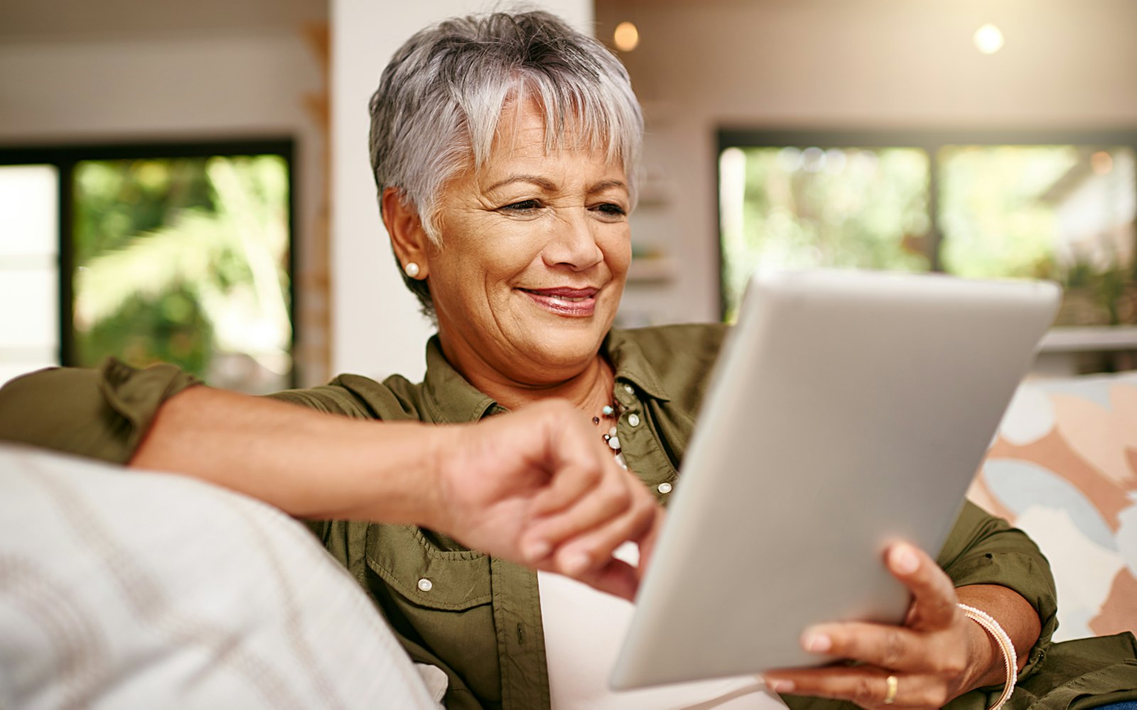 woman reading tablet on couch