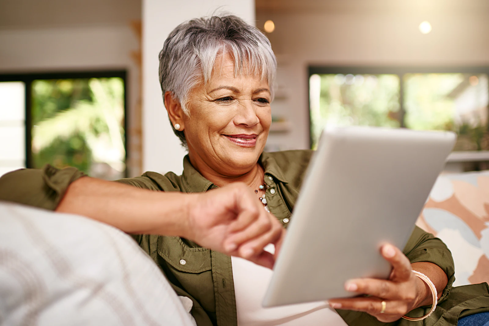 woman reading tablet on couch
